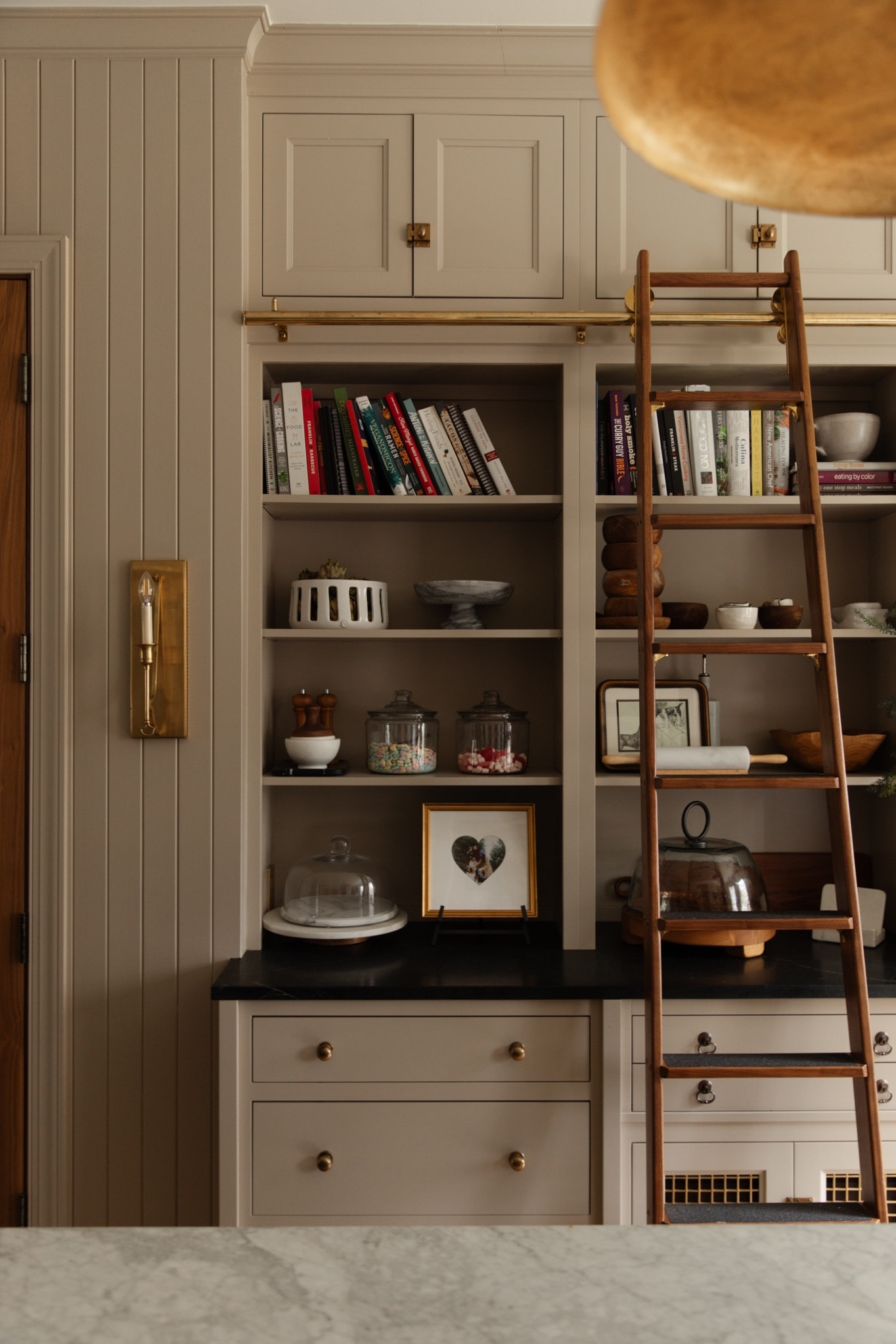Simple way to add a touch of Valentine’s — enjoy candy as decor!!

Kitchen, open shelves, sliding ladder, taper sconce, jars, candy, heart picture frame, cloche, cookbooks, cake stand 

#LTKstyletip #LTKhome #LTKSeasonal