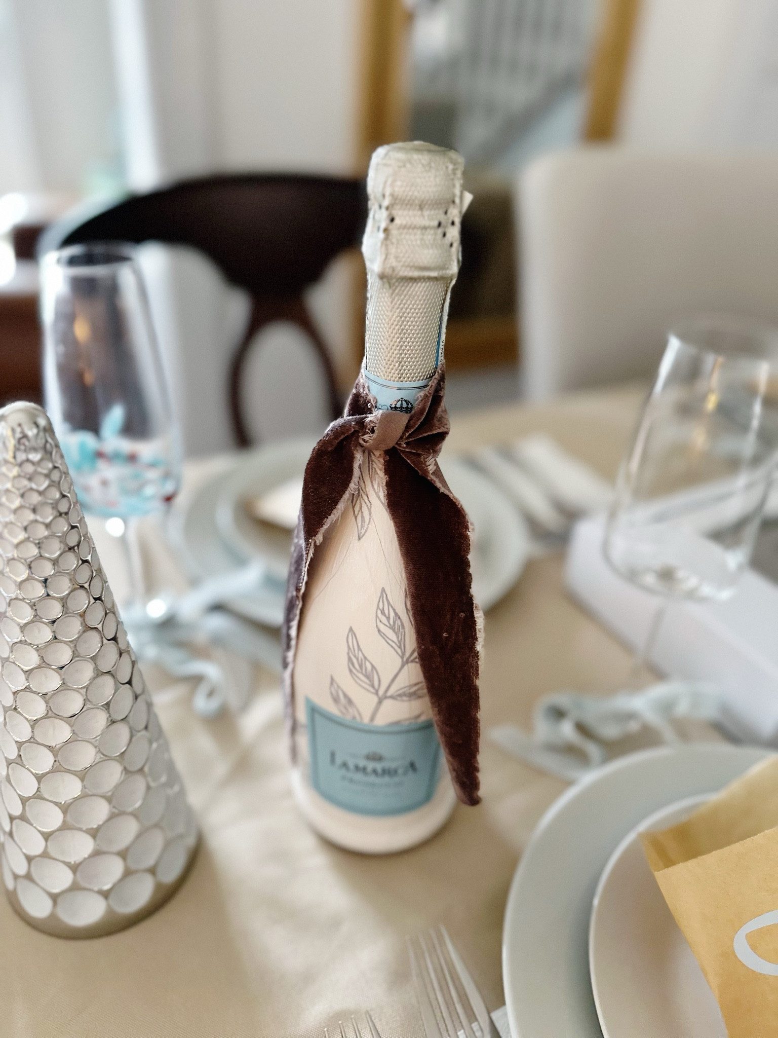 These custom champagne bottles were such a fun diy for brunch. It’s so easy… everyone can do it!

Step 1: Use painters tape to protect the bottle’s label.

Step 2: Use acrylic paint to paint the  exposed glass on the bottle. Let it dry and repeat. You’ll likely need 4 coats before it covers completely. 

Step 3: Cut out your the designs from your paper napkins. You just need a single layer. 

Step 4: Paint Mod Podge onto the bottle where you want to place your cut outs. Put the cut outs on top of the Mod Podge. Paint a layer of Mod Podge over the cut out. It dries clear so no worries about getting a little sloppy. 

Step 5: Tie a ribbon onto the bottle, chill and place on your table or give as a gift! 

I used the matching napkins to my table for a cohesive look. It helps tie everything together! 

Hostess gift, celebration gift, wedding diy, baby shower diy, dinner party

#LTKGiftGuide #LTKwedding #LTKparties