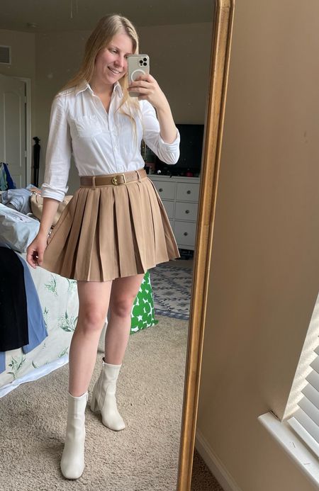 Tan pleated tennis skirt with belt and white collared Oxford shirt and booties under $50  

#LTKunder50 #LTKSeasonal