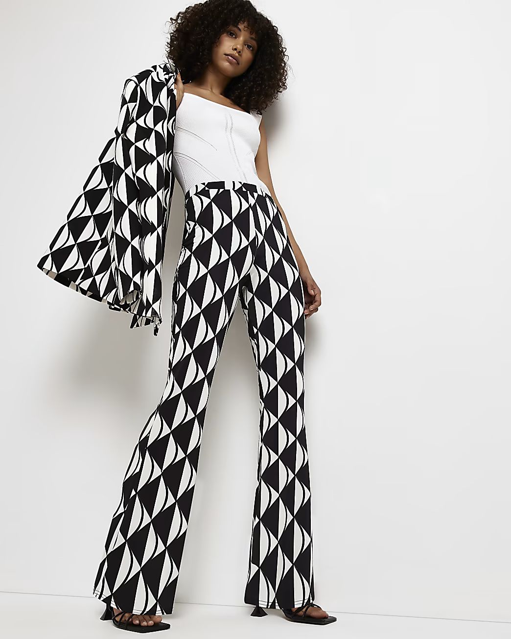 Black geometric print flared trousers | River Island (UK & IE)