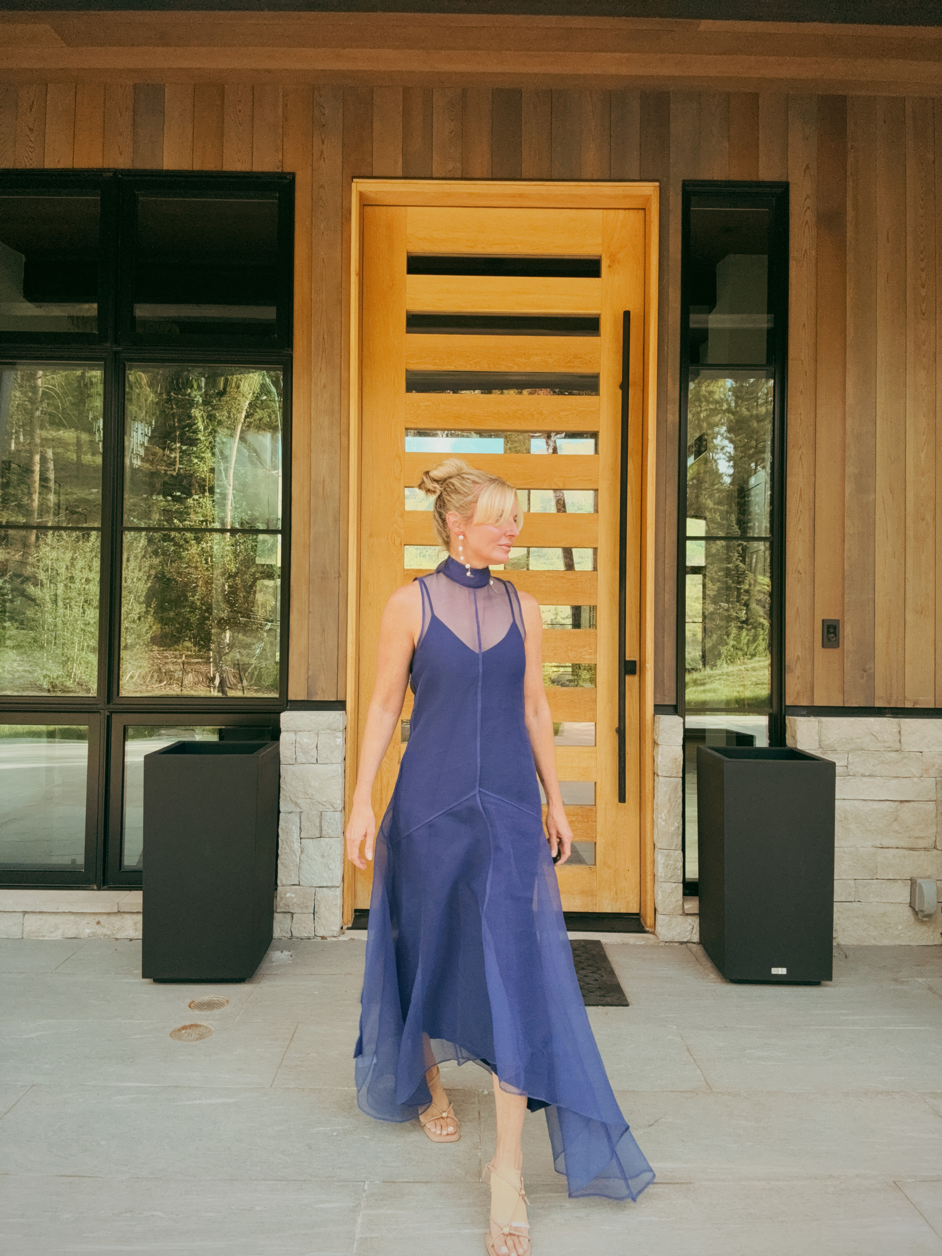 Navy chiffon in natural light is something else entirely!

This Staud gown with its sheer overlay, choker neckline, and handkerchief hem is a summer evening dress that earns every compliment. The sheer layer over the slip gives it that ethereal quality that photographs beautifully outdoors. Pearl drop earrings and nude sandals keep the focus exactly where it belongs; on the dress. 

 #LTKdayinmylife #LTKgrwm #LTKOver40