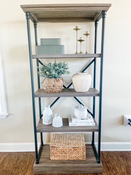 Bookcase styled with stacked boxes, vase, greenery, woven basket, candle stick holders 

#LTKFind #LTKhome