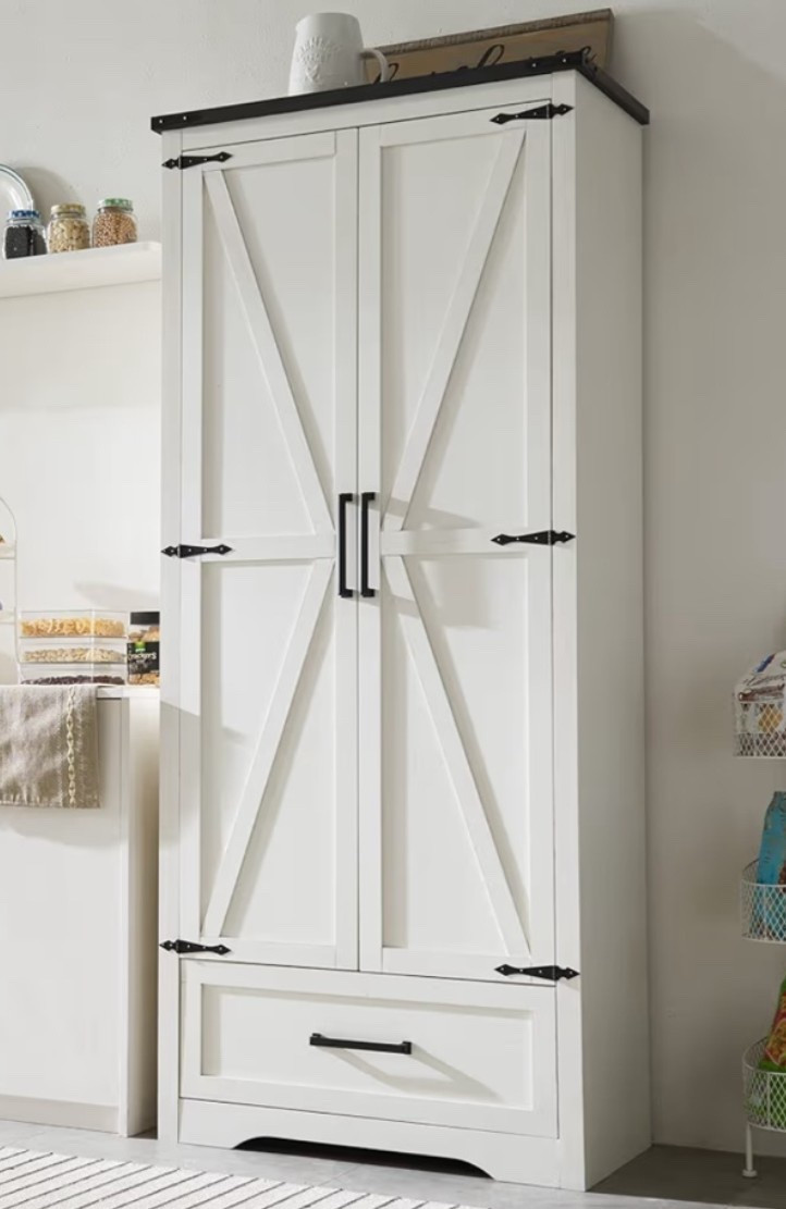 Tall farmhouse pantry cabinet with that cozy antique farmhouse feel that makes a kitchen or dining space look instantly warmer and more organized. 🌾🐄🍎 Perfect for pantry storage, coffee bars, dining rooms, bathrooms, entryways, or living spaces when you want extra storage that still feels decorative and collected. The antique white finish, barn style doors, adjustable shelves, and drawer give it that timeless countryside look while still working beautifully in modern farmhouse homes. 

Add this cabinet if your home needs a pretty storage piece that feels both practical and elevated. 🪿🪺🍅🌿

#LTKHome #LTKOver40 #LTKfoodie