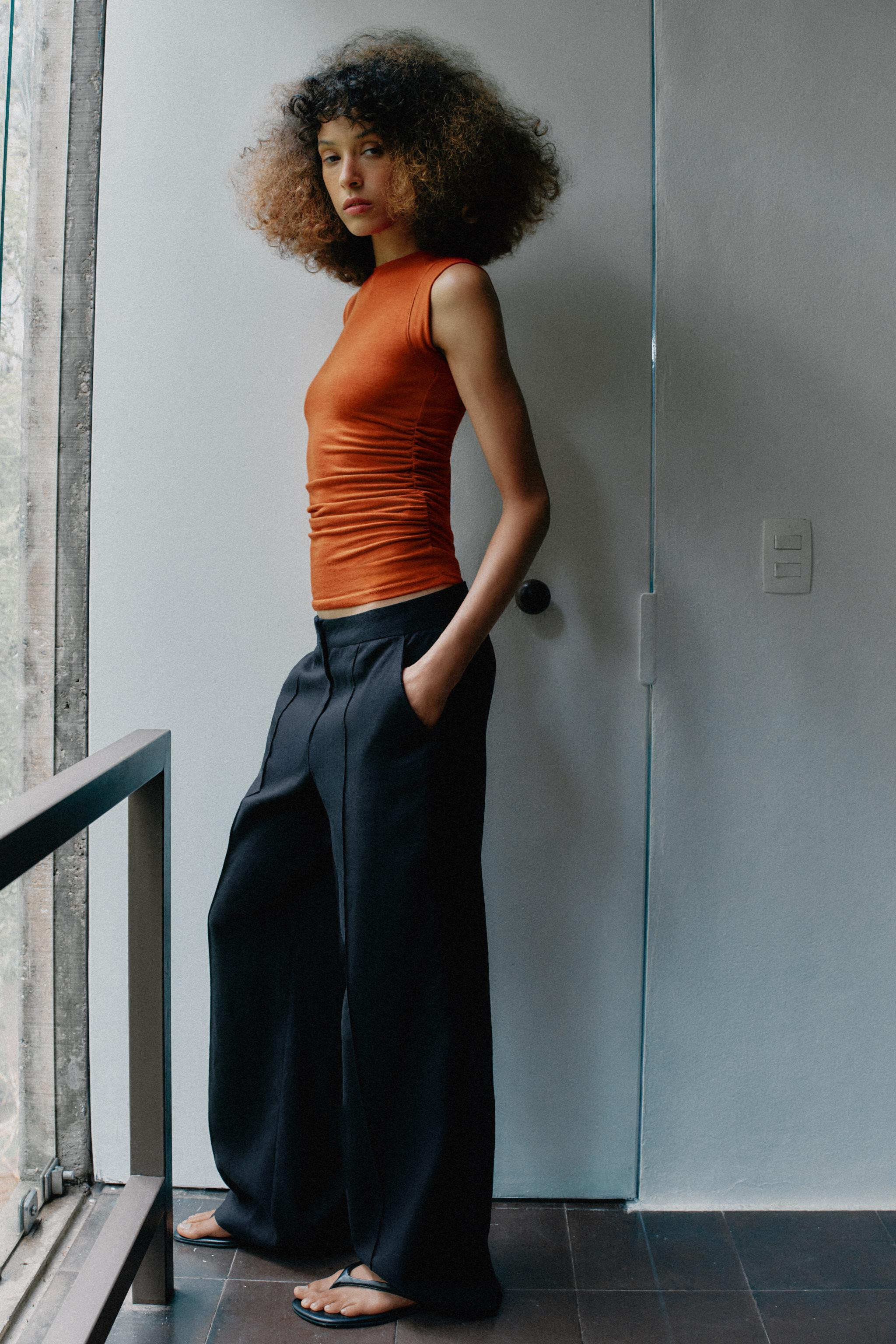 Top made from yarn with 35% viscose. Round neck and sleeveless. Side draped detail. Rounded hem. | Zara US