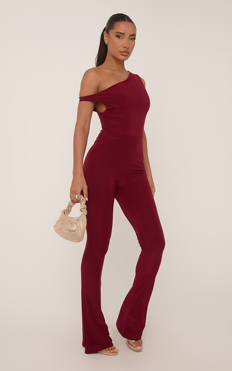 Asymmetric Shoulder Flared Jumpsuit In Burgundy Slinky | EGO Shoes (US & Canada)