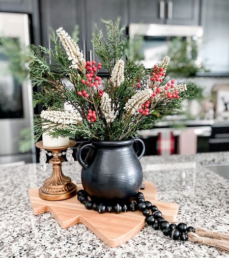 I love styling a basket or tray on the kitchen island with a candle and greenery or flowers for Christmas it isn’t any different except I used a cutting board instead of my wicker basket trays 

Christmas Island decor • Christmas wooden cutting charcuterie board • wooden beads • pottery vase • holiday stems • cedar pine stems • Holly berries •  candle 

#christmasdecor #holidaydecor #hollidayareangement 

#LTKhome #LTKSeasonal #LTKHoliday