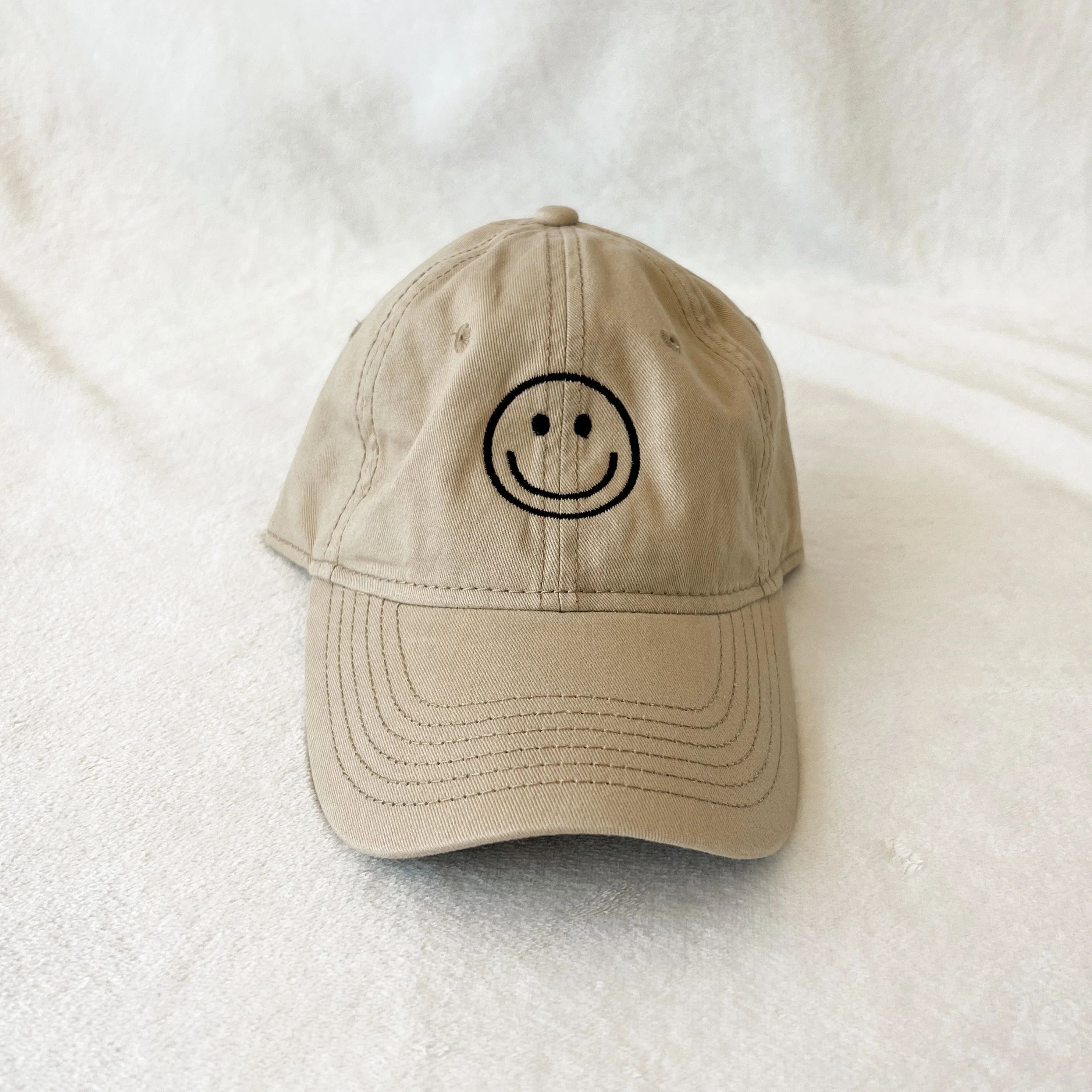 smiley face hat | sand | Reef rain aria