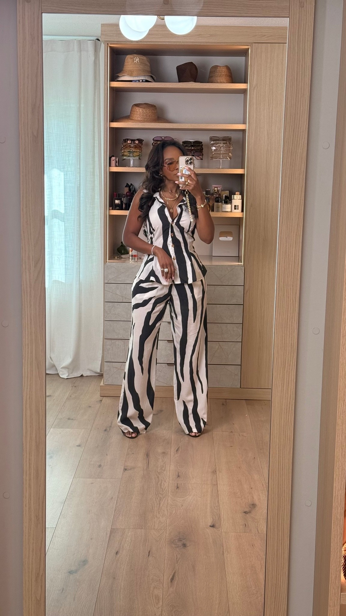 Hi Babes! 🖤🤍✨

This black and white printed set is the definition of effortless chic! I love a matching set that instantly looks put together, and this one is lightweight, flattering, and perfect for everything from vacation to brunch.

✨ Fit Details:
• Wearing a size Small
• Matching sleeveless button-front top
• High-waisted wide leg pants
• Lightweight, breathable fabric
• Styled with layered gold jewelry, oversized sunnies, and black heels

🖤 Where to Wear:
• Vacation sightseeing
• Brunch with the girls
• Resort dinners
• Summer parties
• Date night
• Weekend outings

Matching sets are always a yes because you can wear them together or mix and match with pieces already in your closet!

Everything is linked below!

xx, Kira | IG: KirasFashionFinds

Measurements:
Kira: 5'4" | Size Small | 140 lbs