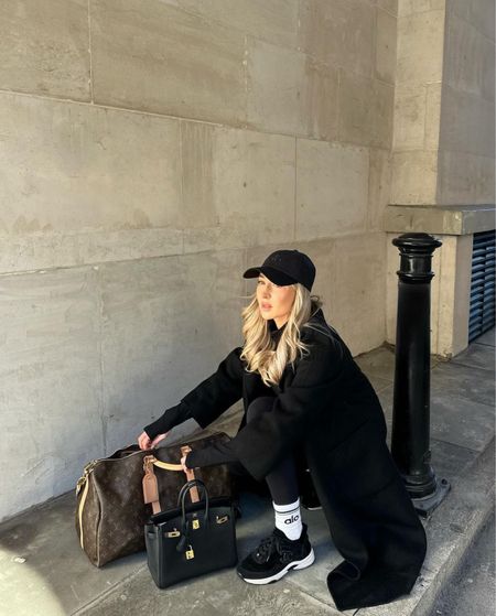 Travel and airport outfit idea 🖤 All black Alo Gymwear, styled with long black coat, Chanel trainers, black cap, Hermes Birkin black and Louis Vuitton travel bag

#LTKstyletip #LTKSeasonal #LTKtravel