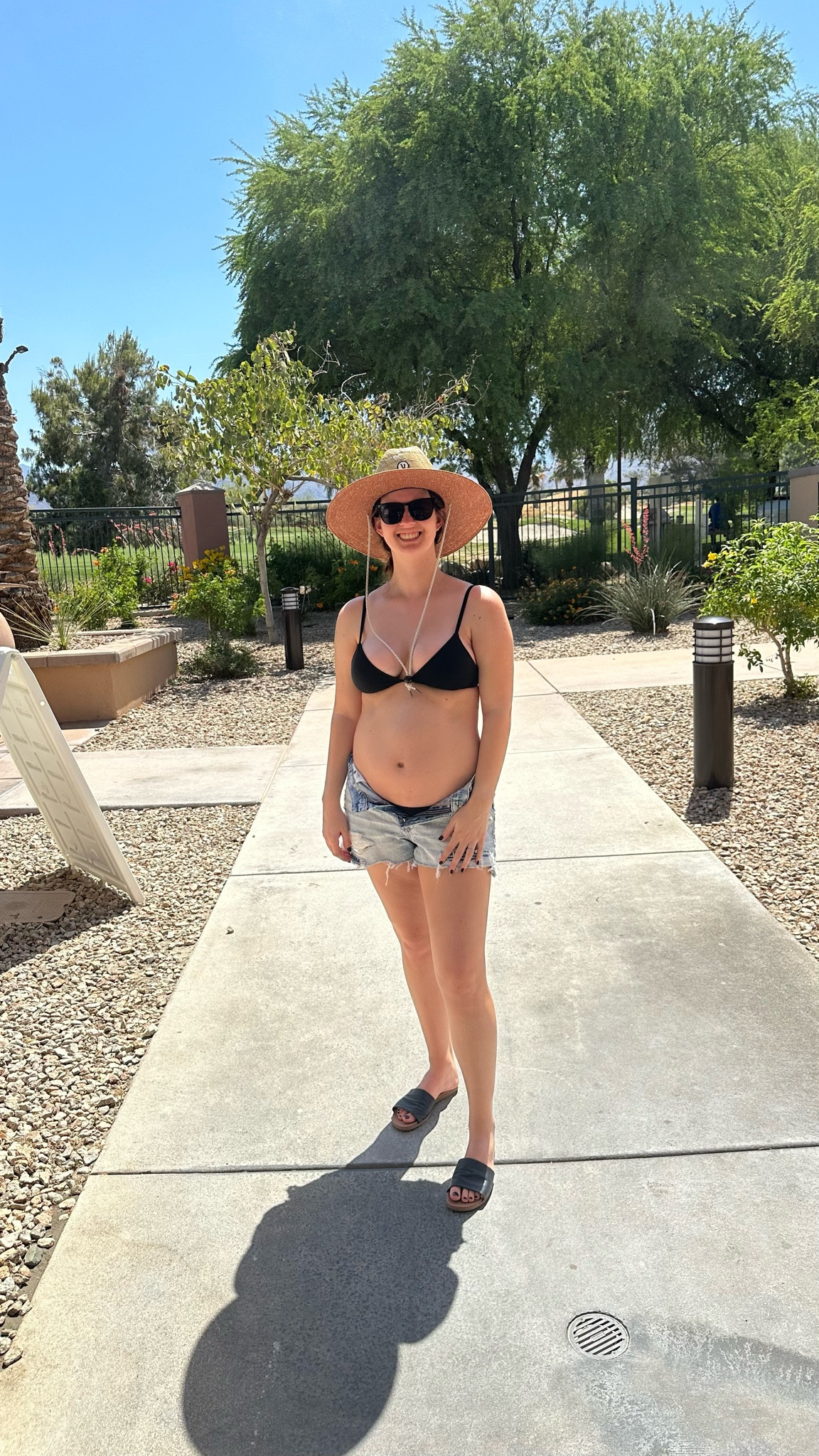 Maternity Swimsuit Outfit! 5 months pregnant enjoying a sunny pool day wearing Aerie black swimsuit with American Eagle jean shorts and a hat from Vuori  

#LTKshoecrush #LTKswim #LTKbump