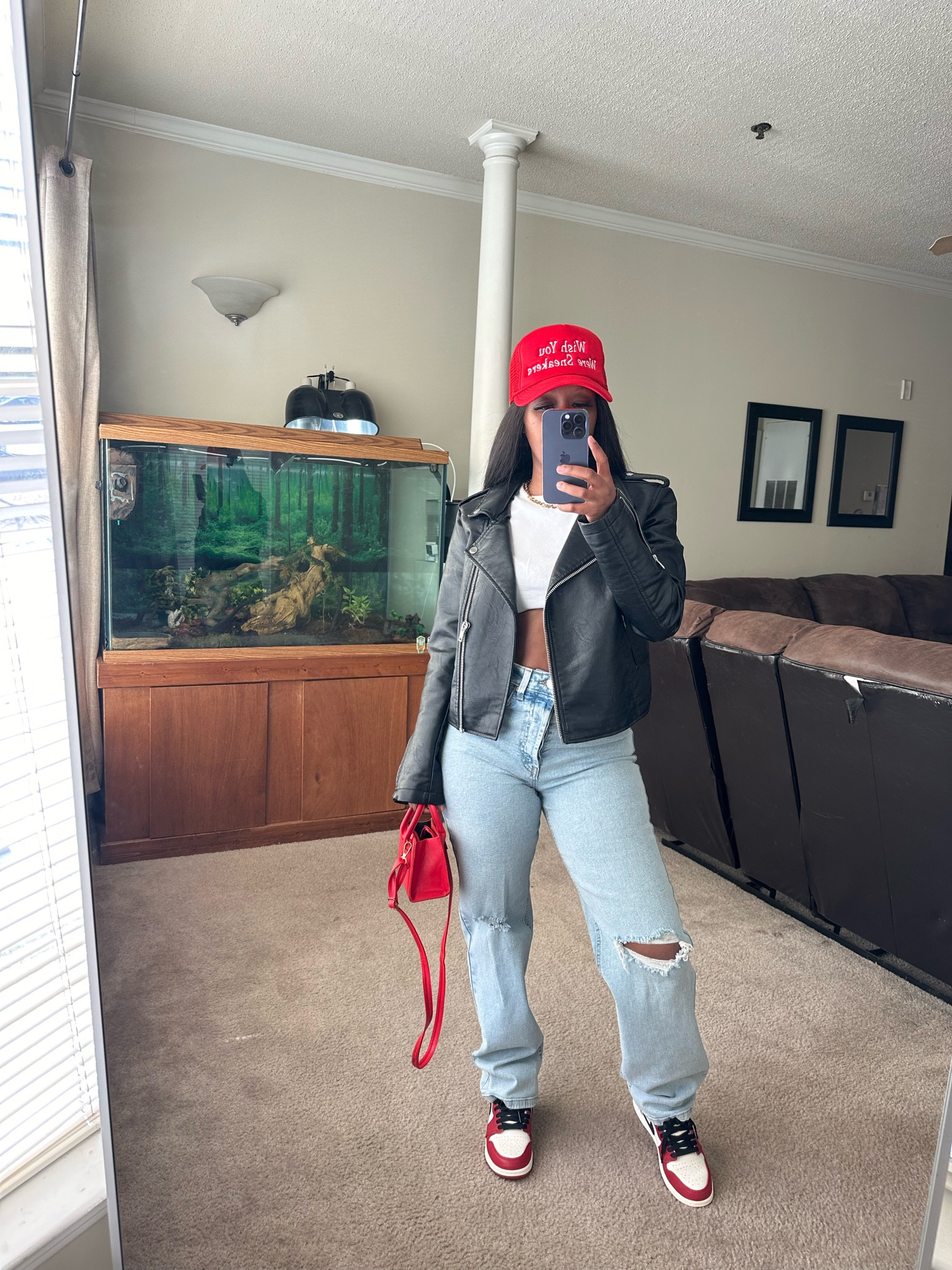 How to style a black leather jacket with a white crop top and distressed jeans.

I styled this casual outfit with a red trucker hat, red purse, and Jordan 1 lost and found sneakers 

#LTKSeasonal #LTKStyleTip #LTKFindsUnder100