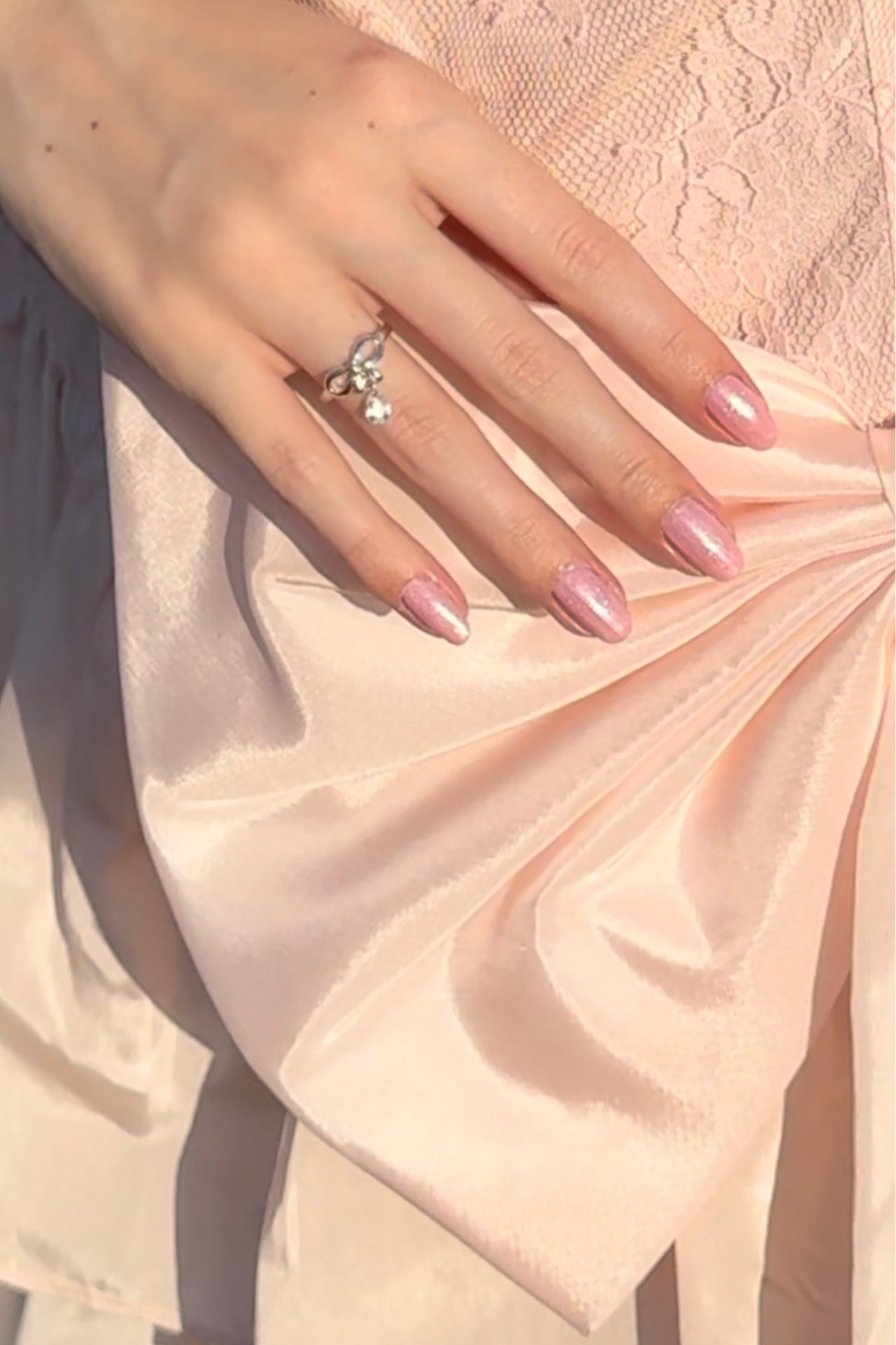 Wearing a cute bow ring with a rhinestone drop detail, along with a beautiful, pink shimmer, long-lasting, manicure. The exact products used for the manicure are listed below as well as the exact ring worn. 💕

#LTKbeauty #LTKSpringSale #LTKfindsunder50