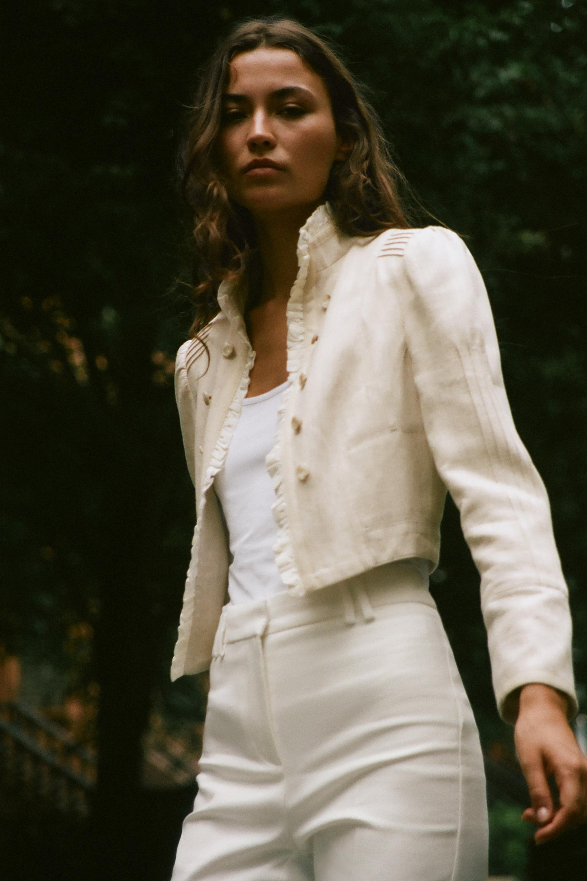 Open blazer featuring ruffles, long sleeves with shoulder pads, and pintuck detailing. Faux front... | Zara US
