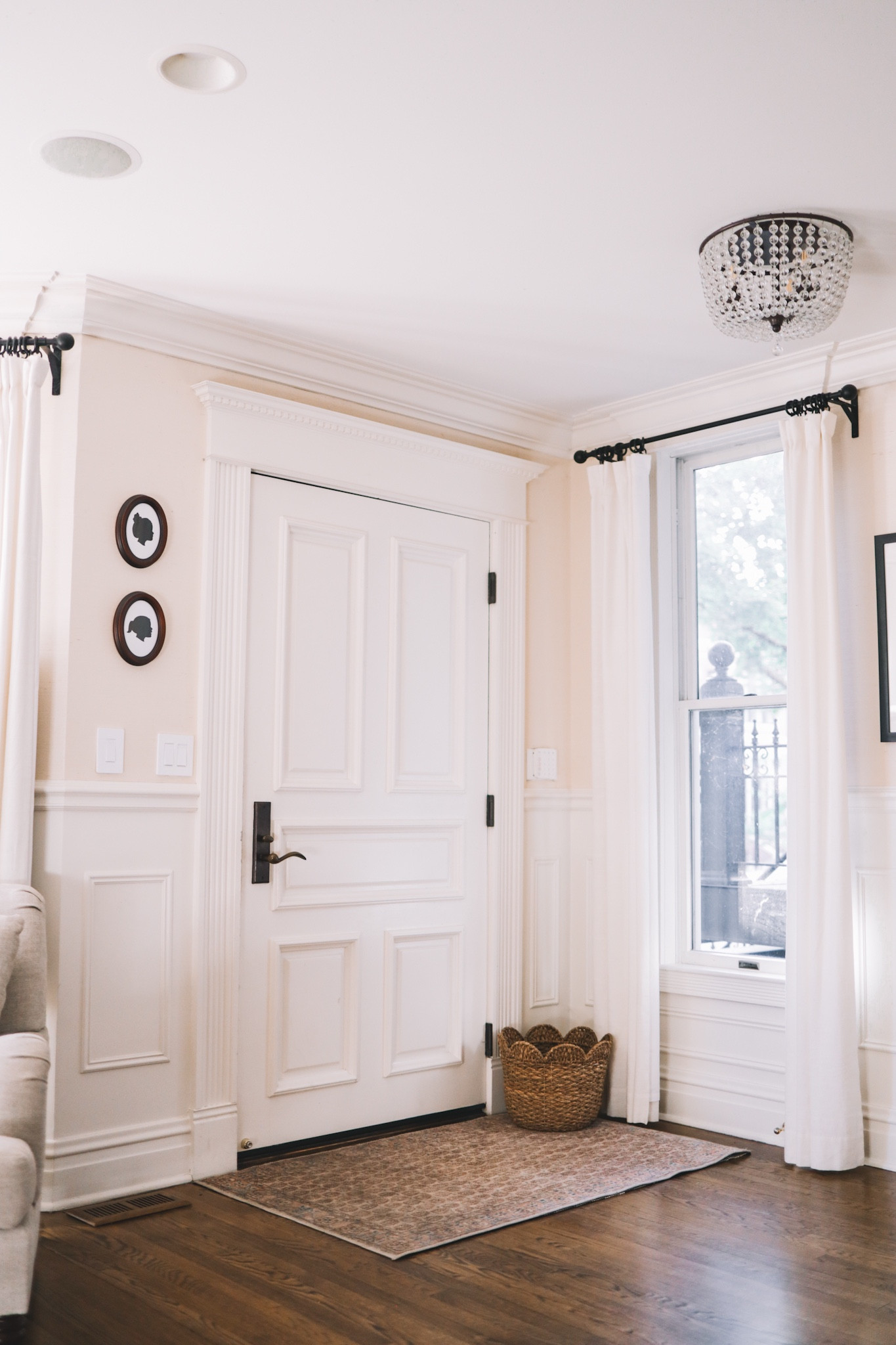 Here's what the front entryway looks like. We recently bought this fabulous polyester Erin Gates rug for the front entrance to replace one that the previous owners left behind. (Yes, it took us five years to do that; what can we say? Ha!)

So happy with it. As Chicago gets a lot of crummy weather—especially in the winter—a tough entrance rug is so important unless we want the wood floors to get wrecked. This rug rarely shows dirt, and is super easy to clean. It's not supposed to be thrown in the washing machine, but I feel like it could totally withstand that on delicate if absolutely necessary?! It's a great rug, and I can't recommend it more for high-traffic areas.

Oh, and I should note that our walls are actually wallpapered, not painted! (It's kind of hard to tell in photos.) We used Annie Selke's classic grasscloth wallpaper in cream, though since that color is out of stock right now, I'm linking some other very similar options.