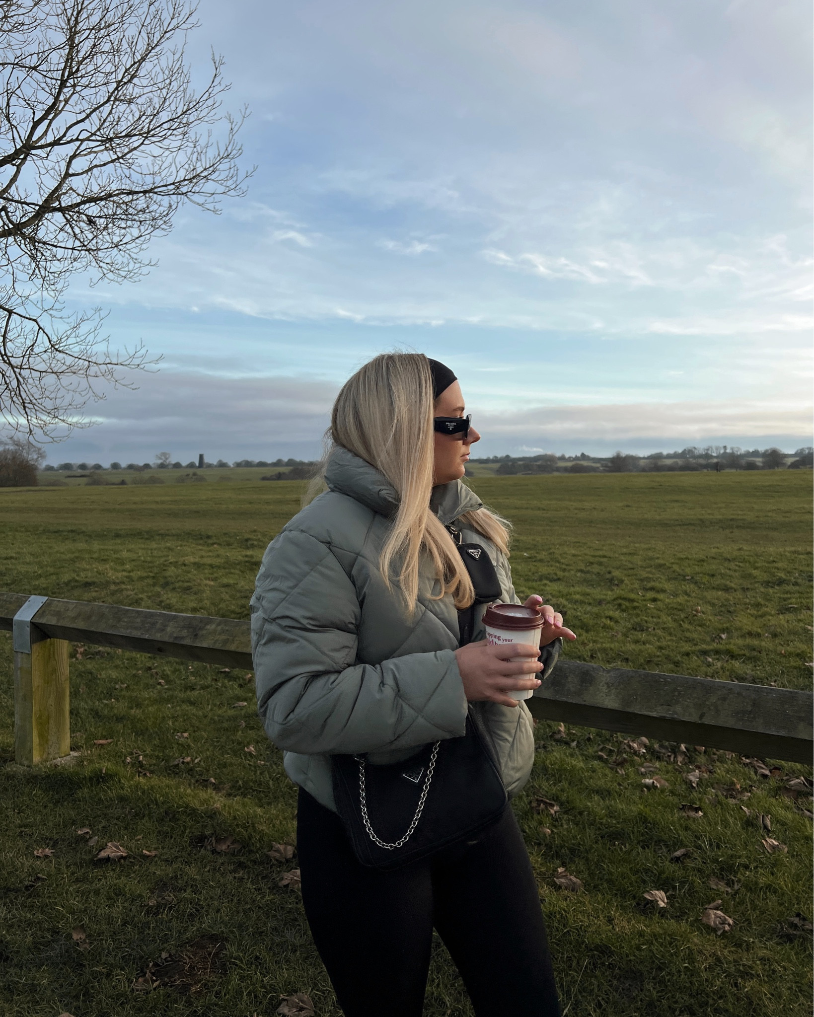 an olive/khaki/green quilted puffer jacket, black seamless leggings, flat knee high boots with a cross body nylon prada bag, prada square sunglasses and a black headband

#LTKeurope #LTKstyletip #LTKSeasonal