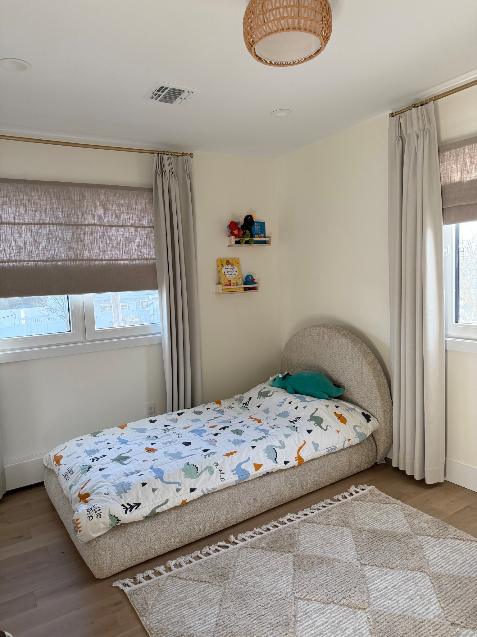 Sharing my son’s room ✨ This upholstered bed instantly made the room feel warm and elevated and I love pairing it with simple layers like linen curtains, Roman shades, woven lighting, and a soft neutral rug. The little dinosaur bedding adds the perfect fun touch for him without overwhelming the space. He is loving it 🧡

#LTKBaby #LTKHome #LTKKids