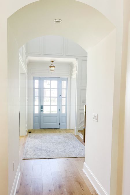 Classic coastal foyer with blue painted door & brass light fixture 

8’ Knotty Alder 8-light Door with sidelights and seedy glass 

Paint color: SW Honest Blue at 75%

#LTKhome