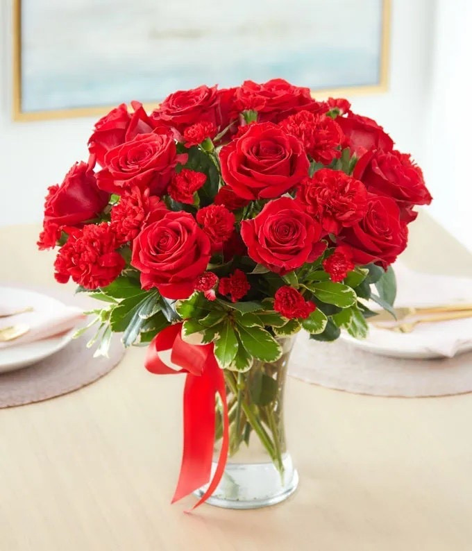 Let your love bloom on Mother’s Day with this beautiful, lush bouquet. This all red flower arrangement is hand-arranged by a local florist near you with classic red roses, along with red carnations. All the red flowers make this gift a wonderful way of letting someone in your life know they are important to you and you appreciate all the love they give you. The red roses and carnations are delivered in a clear glass vase with a red ribbon tied around the center. Measures 17"H by 15"L. Multiple sizes available, regular floral arrangement shown. 

Includes:
• Red Roses
• Red Carnations
• Miniature Red Carnations
• Clear Glass Vase with Red Ribbon
• Complimentary Card Message

Keywords:

* red rose bouquet
* mother’s day bouquet
* mother’s day gifts
*gifts for mom
* rose and carnation bouquet
* fresh flower delivery
* floral gift arrangement
* love bouquet
* appreciation gift
* meaningful flowers
* thoughtful gift idea

#LTKSaleAlert #LTKMothersDay #LTKHome