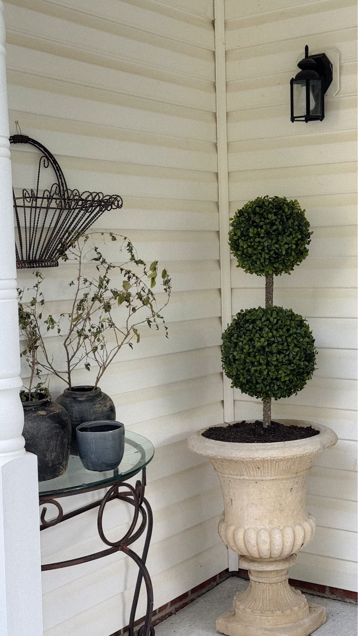I transformed my front porch using mostly secondhand vintage finds to create a timeless, collected outdoor space on a budget.