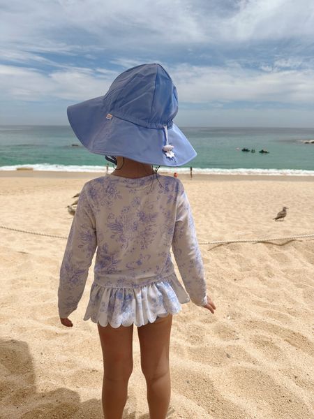 Upgrade your girl's swimwear with this comfy and stylish One Piece Rash Guard from RuffleButts! Unlined with bottom snaps for easy changes, and sun-protected for all-day fun. #RuffleButts #Swimwear #SunProtection

#LTKkids #LTKSeasonal #LTKswim