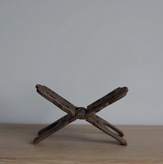 A beautifully carved, vintage-inspired book holder that adds warmth and texture to any styled surface. Perfect for displaying your favorite design book, cookbook, or collected piece in a thoughtful way. Its timeless craftsmanship and rich wood tone make it an effortless addition to neutral interiors and intentional home styling. A simple detail that elevates every vignette — from kitchen counters to coffee tables.

#LTKStyleTip #LTKGiftGuide #LTKHome