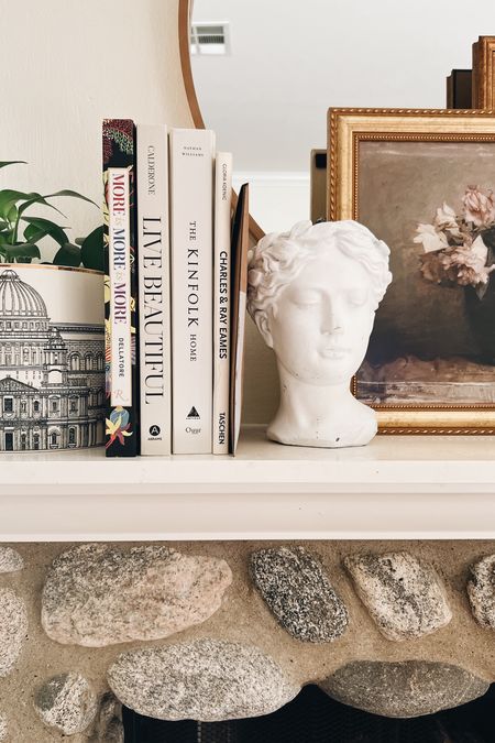 A little close up of our fireplace mantel decor!
-
Grecian bust planter - Athena Calderone Live Beautiful - Eames coffee table book - Kinfolk coffee table book - Maximalist coffee table book - minimalist coffee table book - large round wood frame mirror - vintage floral art - attica press curated gallery wall - Amazon - Etsy - shelf decor -
Fireplace decor 

#LTKhome #LTKunder100 #LTKunder50