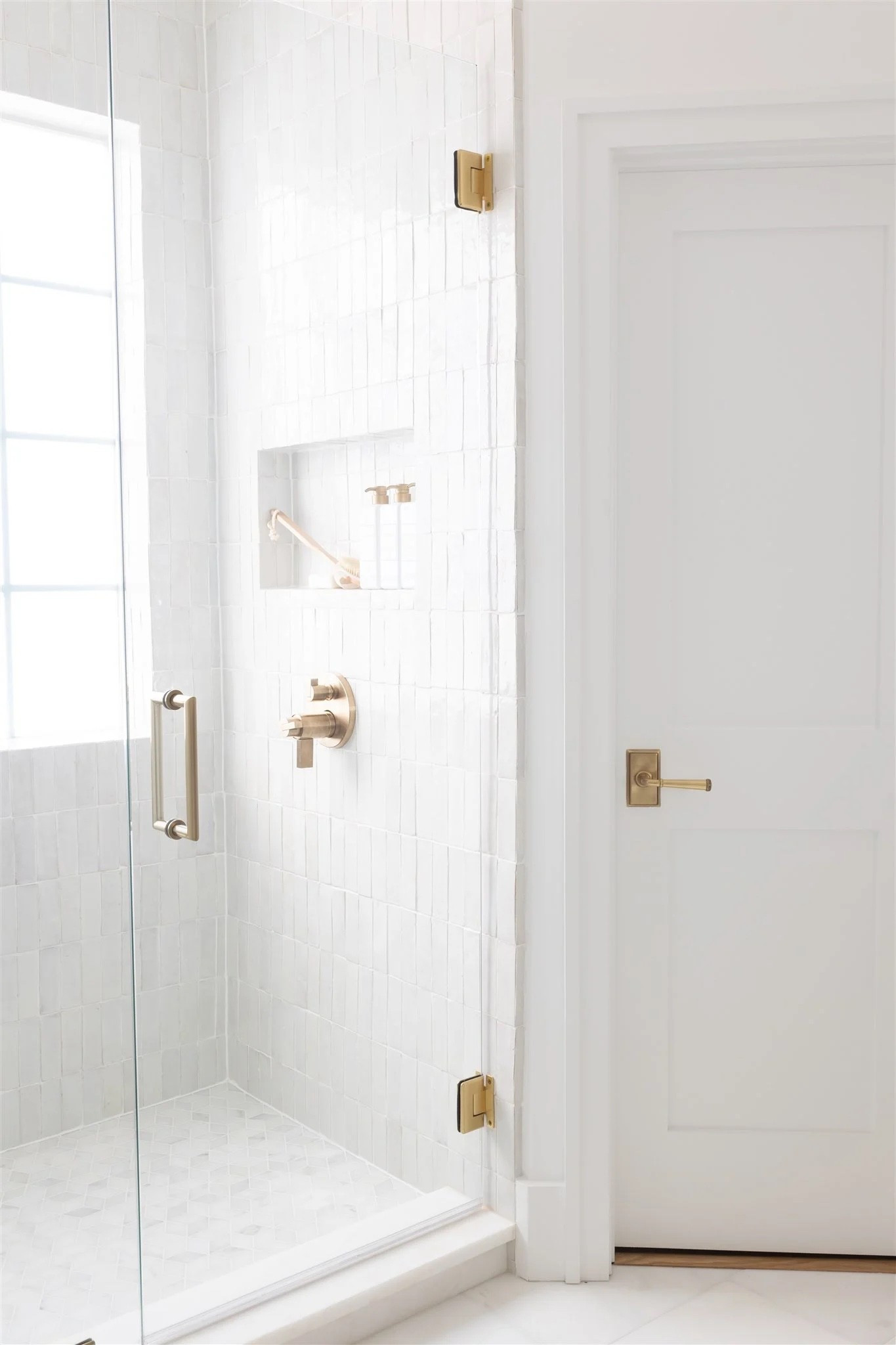 Our primary bathroom renovation: Snow White Zellige shower tile, Carrara marble flooring, and antique brass hardware. Shop the tile, marble, and fixtures we used to get this timeless Moroccan tile look in a coastal bathroom design.

#LTKHome