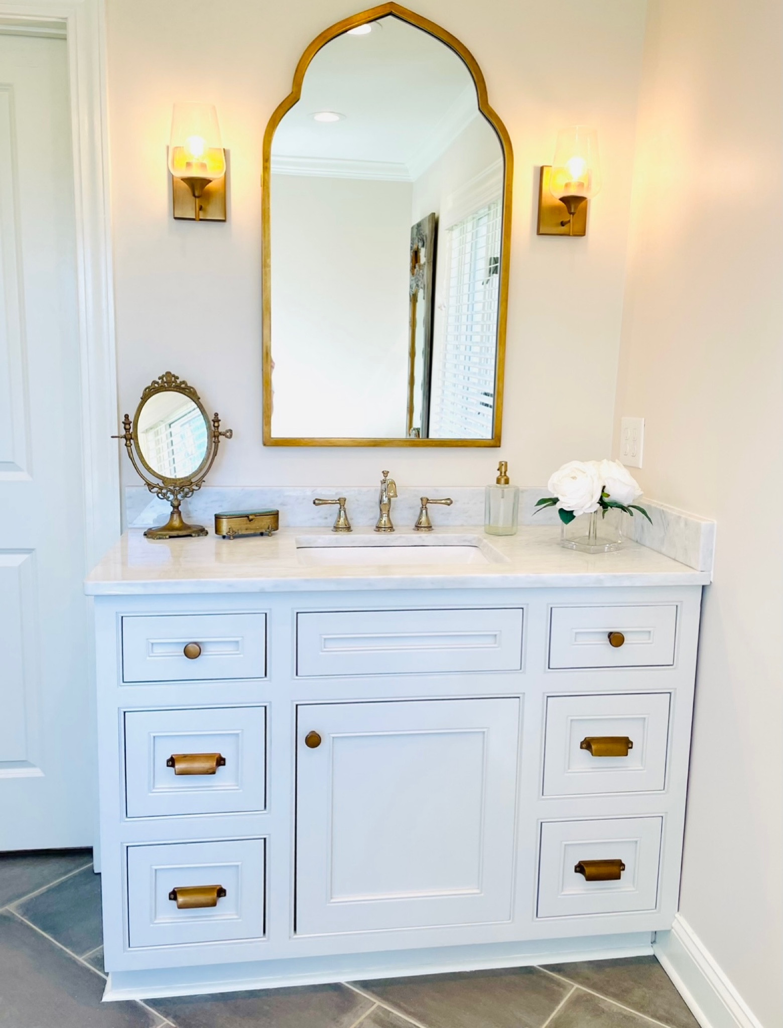 Shop my master bathroom - master bathroom, vanity, white vanity, marble, gold mirror, gold sconces, gold cabinet hardware, polished nickel, mixed metals, mixed finishes 

#LTKstyletip #LTKbeauty #LTKhome