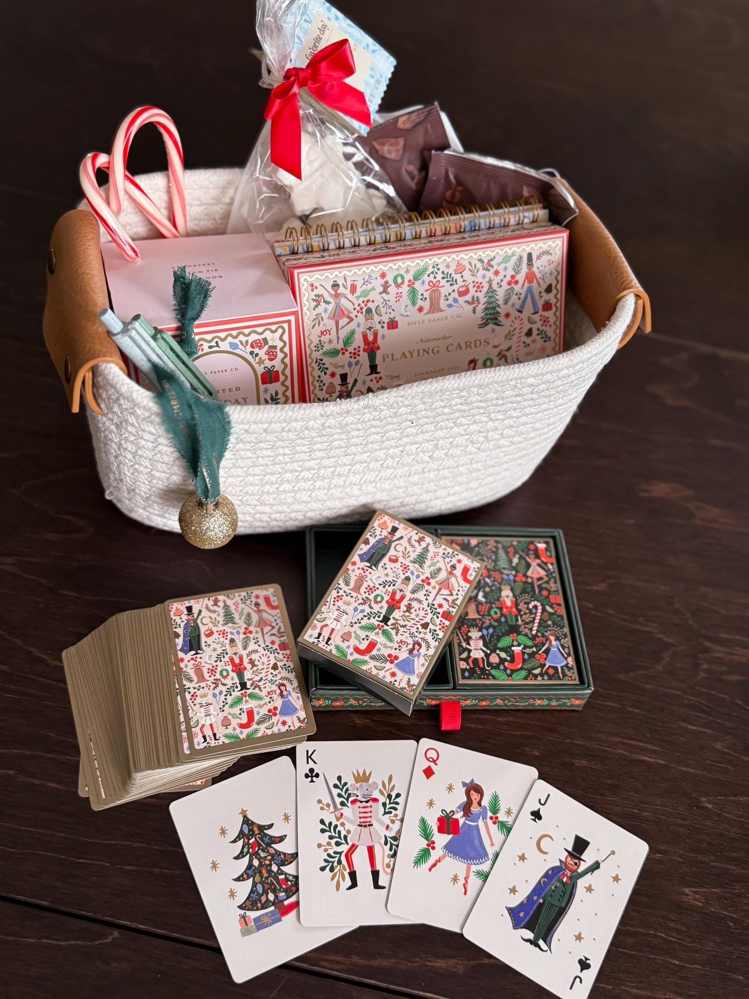 Gift idea for the friend who loves playing cards.
Nutcracker themed playing card deck.
A candle for cozy ambiance 
A new notepad and pens for score keeping
Hot cocoa and fun marshmallows 
And a little DIY ornament gift tag.

#LTKHoliday #LTKGiftGuide #LTKFamily