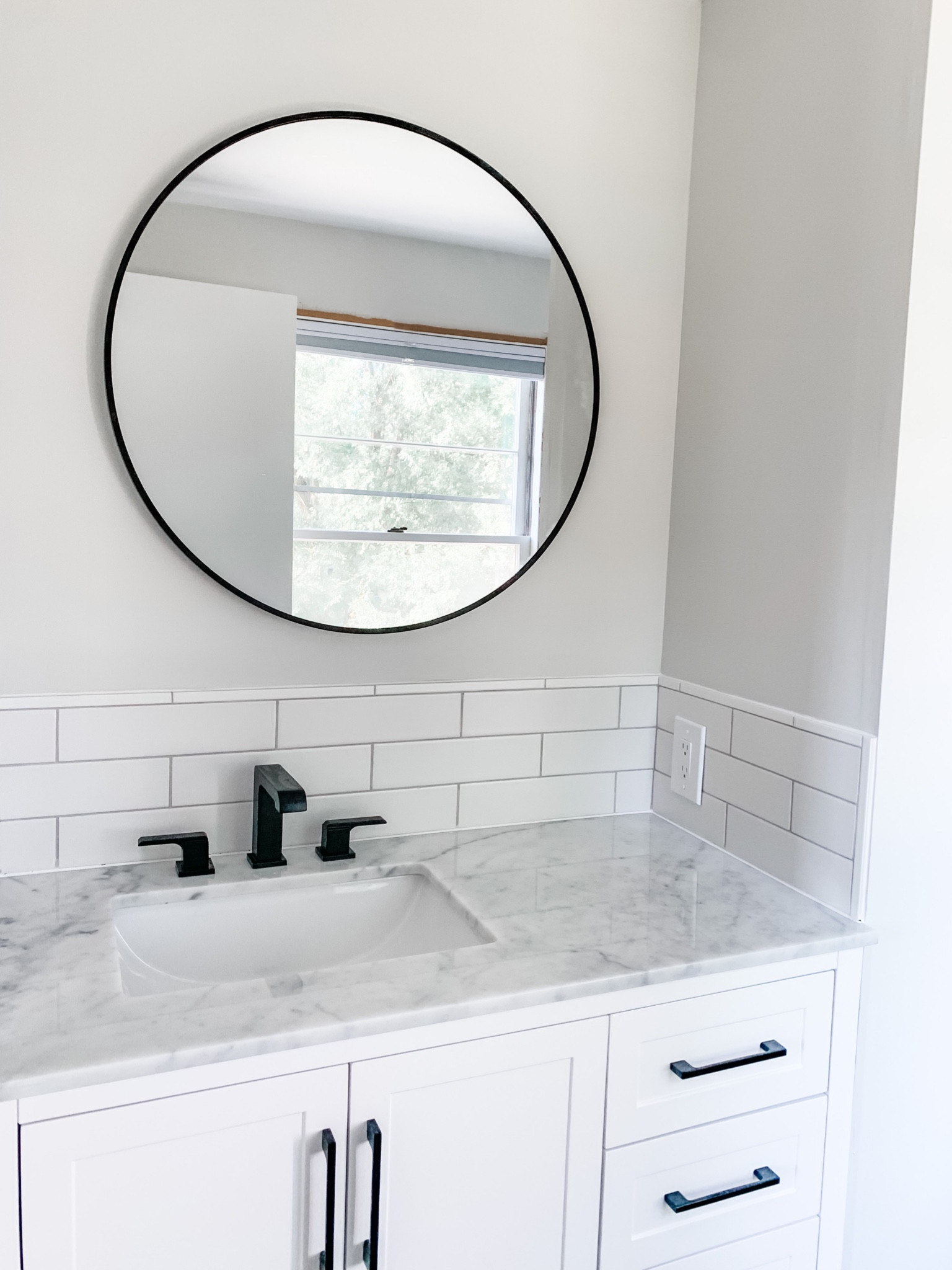 Some details from our master bath remodel. It’s so light, clean and airy! 

Round black mirror white subway tile marble vanity 

#LTKhome