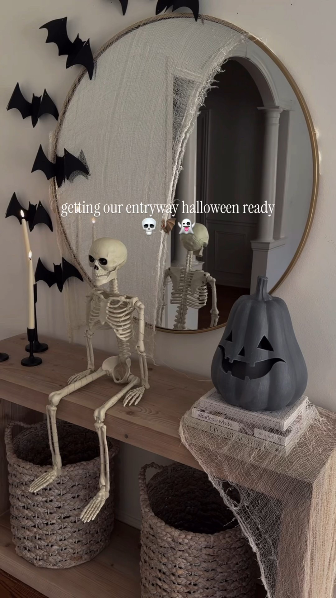 When chic meets spooky 👻✨ We had so much fun putting together this Halloween entryway bats on the mirror, a glowing skeleton, and the happiest little pumpkin