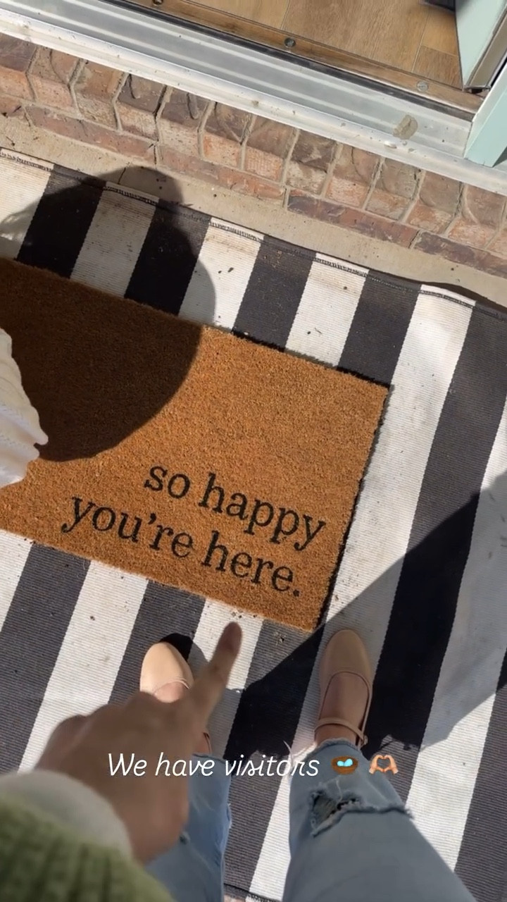 Front porch refresh + we have visitors 🪺 🫶🏼 Found the cutest welcome mat that says “I’m so glad you’re here“.  And it’s only $13 at target!! Layered it with a black and white bold striped rug. Also linking my DIY wreath hanging basket and faux stems! These are the prettiest pink peonies from Amazon.  So pretty that the birds decided to make it home. 🫶🏼🪺

#LTKFindsUnder50 #LTKHome #LTKSeasonal