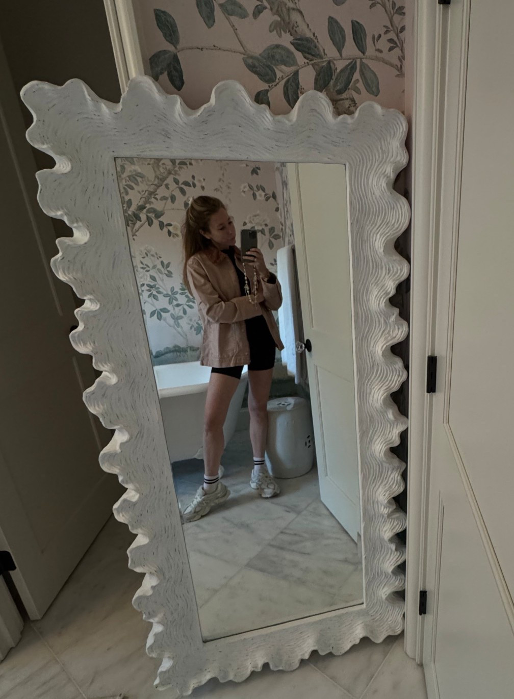 Considering ordering another $60 jacket in a bigger size to wear over workout clothes. Love the XS fit with jeans but a M might cover bottom which would be good. Will report back! 