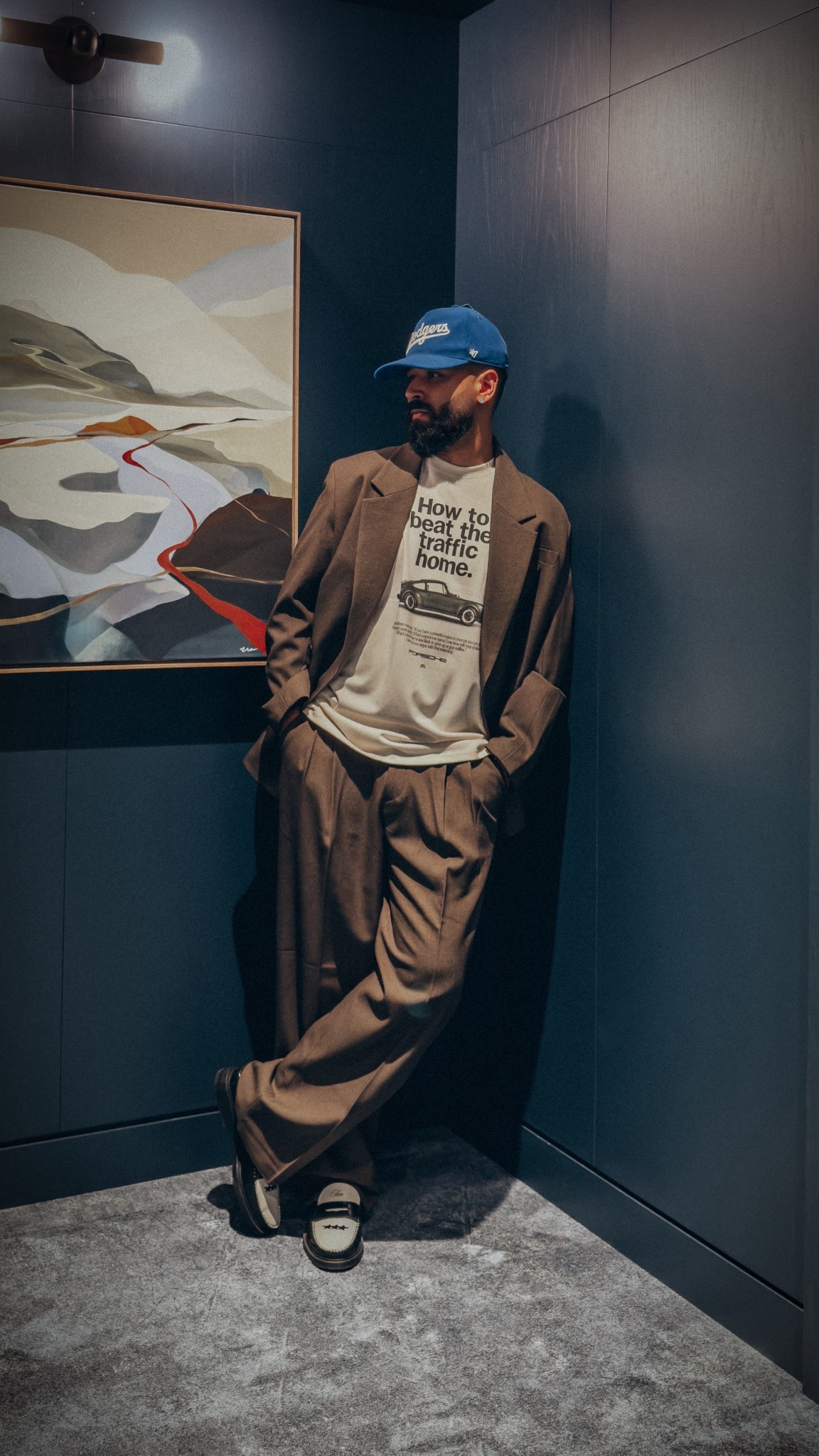 A modern yet nostalgic men’s fall look that’s easy to dress up or down. A relaxed and elevated look. Featuring a ball cap, brown blazer jacket and trouble pleated trouser pants (to complete the suit look), a vintage inspired Porsche tee, and leather penny loafers in black and white. Also linked alternative tops that are more casual to substitute the blazer. Wearing size Large in all tops (and blazer) and size Large in bottoms.

#LTKStyleTip #LTKMens