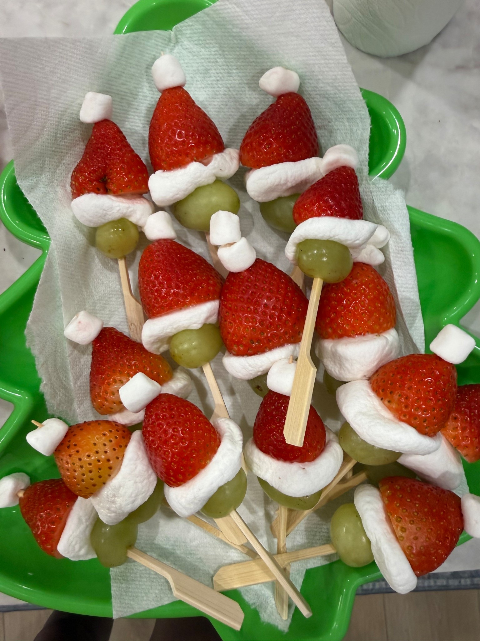 Grinch fruit treats with marshmallow, grapes, and strawberries 