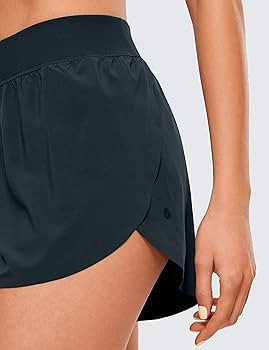 CRZ YOGA Mid Waisted Dolphin Athletic Shorts for Women Lightweight High Split Gym Workout Shorts ... | Amazon (US)