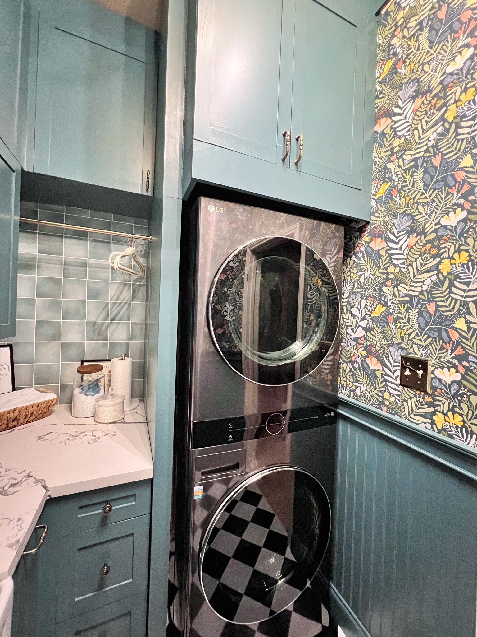 Moody florals, checkerboard floors, and the prettiest little pop of blue-green cabinetry — proof that even a laundry space deserves good design. 🤍 

 #LTKHome #LTKSaleAlert #LTKSeasonal