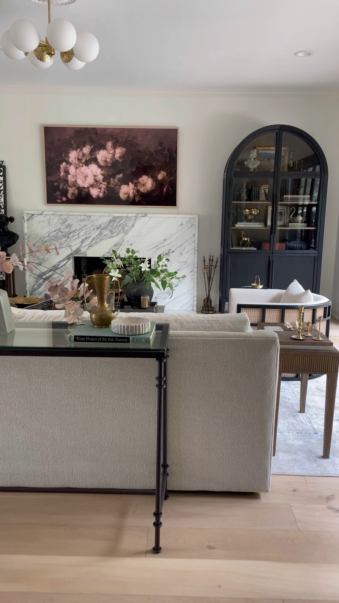 A full view of our living room furniture and decor! I love our modern arch Arhaus cabinet juxtaposed with the ornate iron floor mirror!

#LTKhome #LTKsalealert #LTKstyletip