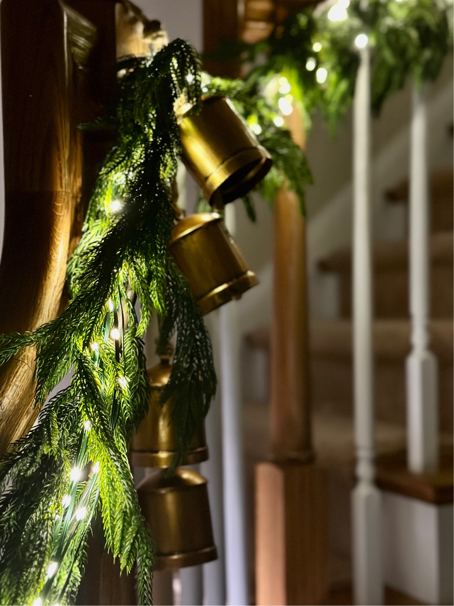 Banister Garland details - I continued the same theme I used on the fireplace mantel, onto the staircase using Norfolk pine real touch Garland, warm white LED string lights, and vintage inspired cow bells on each railing post. I used two 15 foot sections of Garland for a large banister  

Christmas decor inspo // viral Garland // holiday decor // realistic Garland // Christmas bells

#LTKHoliday #LTKSeasonal #LTKhome