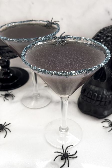 Black Magic Martini 

Ingredients:
¾ oz black vodka
½ oz Chambord
1½ oz cranberry juice
½ oz lemon juice
Glitter/shimmer drink mix amount according to package directions. 

Directions:
Add ingredients into shaker with ice and shake till chilled. Rim martini glasses with glitter sprinkles. Pour drink from shaker into martini glasses. Serve and enjoy!

#halloweendrinks #halloweendrinkrecipe #halloweendrinkrecipes #recipes #halloweenrecipes #halloweenmartini #entertaining #halloweenparty #martiniglasses #blackmartini
#LTKseasonal



#LTKfindsunder50 #LTKhome #LTKHalloween