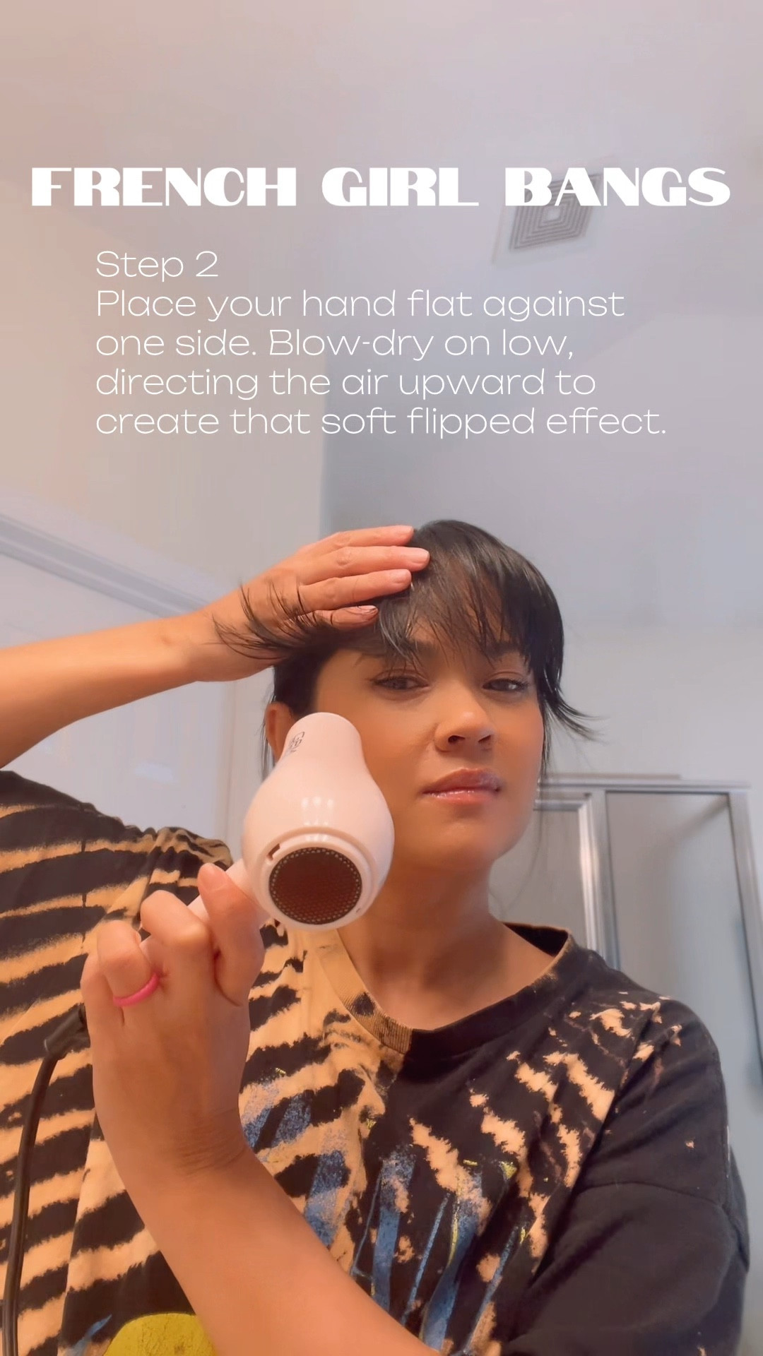 Step 1
Lightly damp your bangs and brush them straight down.

Step 2
Place your hand flat against one side.
Blow-dry on low, directing the air upward to create that soft flipped effect.

Step 3
Repeat on the other side and let the center fall naturally.

Step 4. Blow-dry the middle down with a round brush.

Done ✔️
Less than 5 minutes, no products, and it lasts all day.

#LTKselfcare #LTKOver40