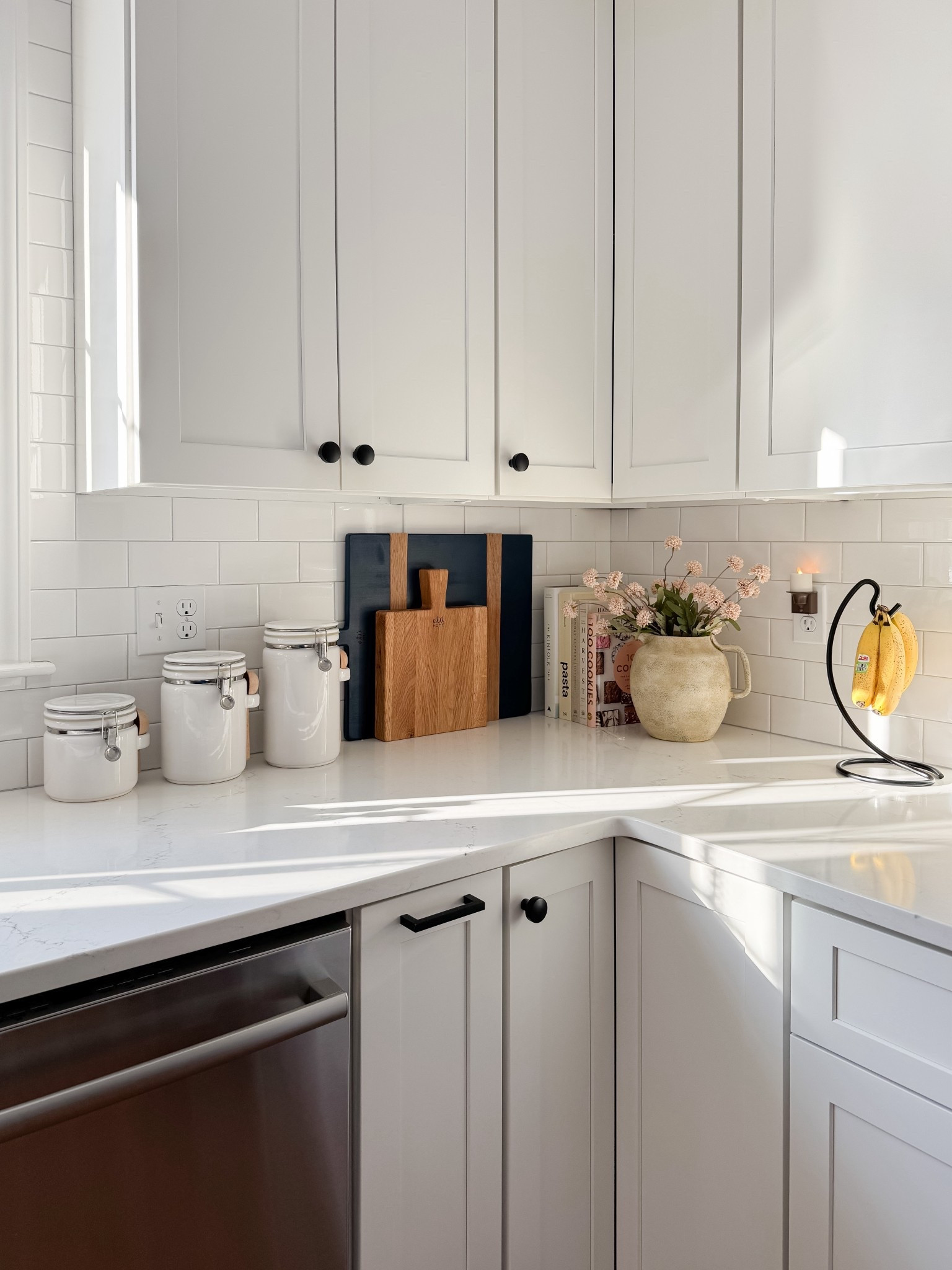 Kitchen counter styling with textured ceramic pitcher vase, soft blush florals, stacked cookbooks, and white subway tile backsplash. Warm neutral kitchen decor for a simple seasonal refresh. 
kitchen counter decor, ceramic pitcher vase, spring kitchen decor, cookbooks styling, subway tile kitchen, neutral kitchen, blush florals, kitchen styling ideas, coastal kitchen decor, simple home refresh, cottage kitchen, everyday decor, sherri calnan home

#LTKHome