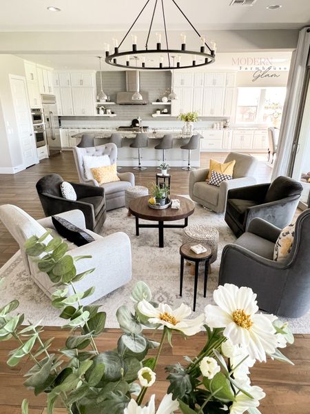 Conversation Area @ Modern Farmhouse Glam 
Swivel glider chairs, neutral extra large 12 ft square area rug, coffee table, end tables, pillows, home decor, furniture. 

#LTKhome #LTKCon #LTKsalealert