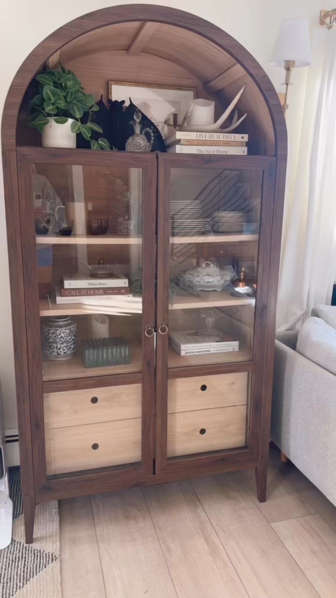 Tall, timeless, and totally versatile 🤍 The Nolan arched cabinet from Wayfair adds instant architecture to your room. We love how its glass doors show off styled ceramics and woven baskets while keeping everything feeling light. Perfect for dining spaces, living rooms, or even a luxe office corner. ✨ Items linked in our LTK for easy shopping!

#LTKhome #LTKstyletip #LTKfinds #WayfairFinds #NeutralDecor #ArchedCabinet #StyledToSell

#LTKHome #LTKStyleTip #LTKSaleAlert