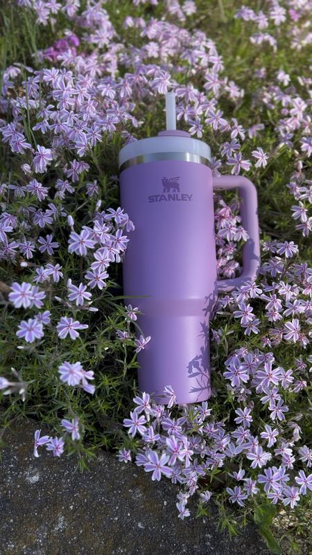 Stop and smell the flowers 💜🌸 My new Stanley Quencher Flowstate Tumbler in Lilac was spotted enjoying a quiet moment among the spring phlox. 🤗 Love that we share common interests like nature walks and gardening. #stanleypartner @stanley_brand