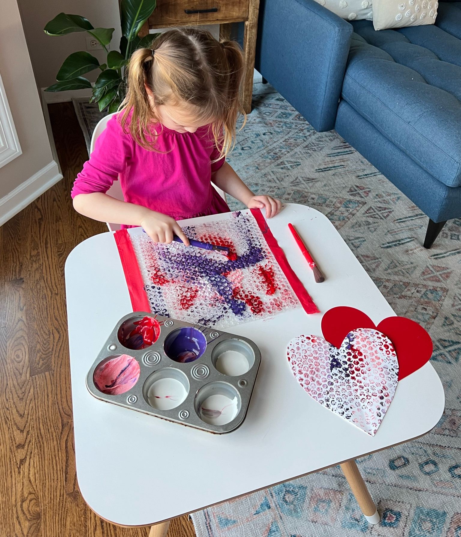 Easy Valentine’s Day craft for kids! 1) tape down bubble wrap 2) paint with reds, pinks, and purples 3) cut hearts out of card stock and press down on the bubble wrap!

#LTKFamily #LTKKids
