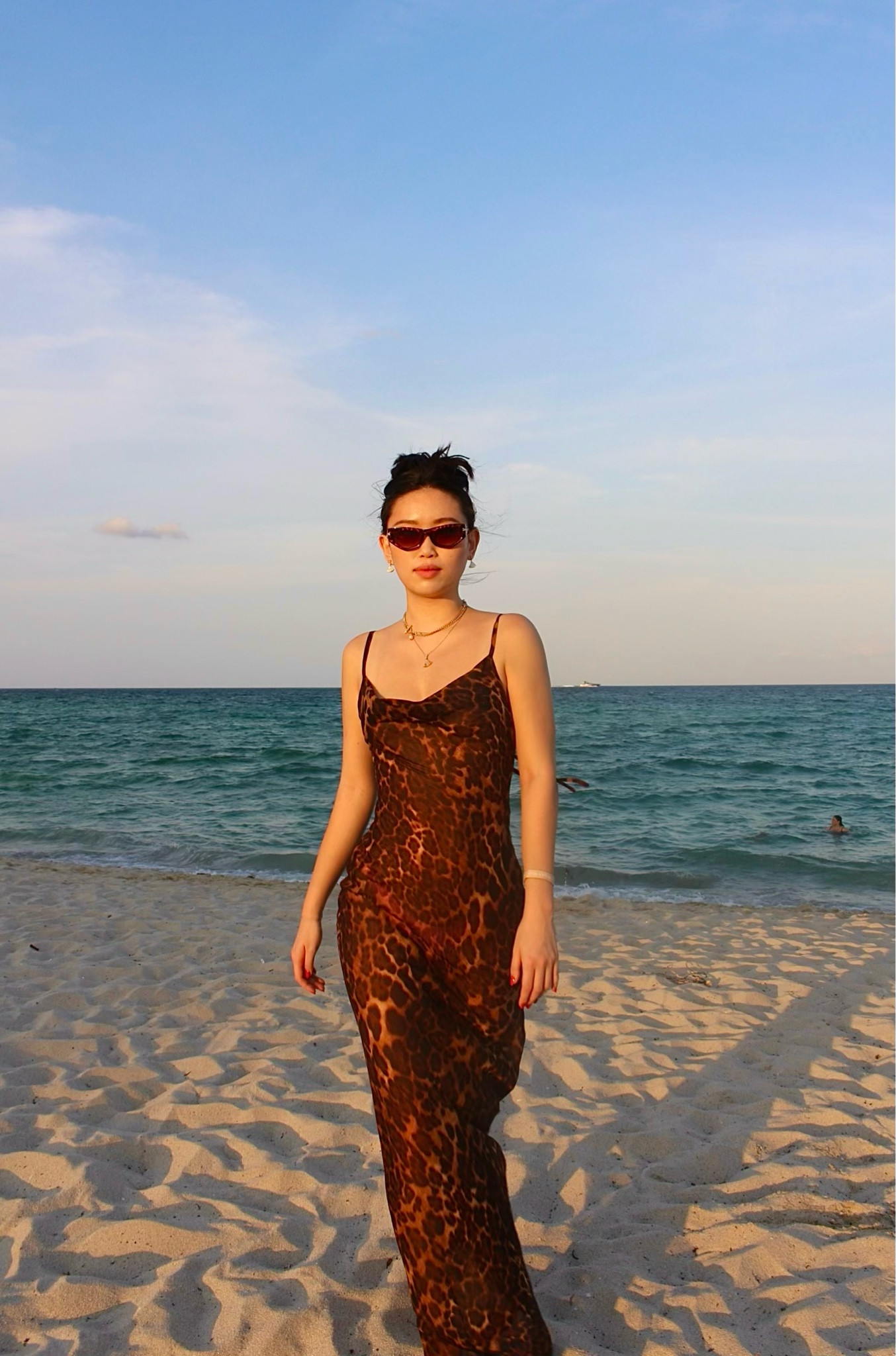 the rat and boa leopard print silk slip maxi dress in size small — a bias-cut spaghetti strap slip with a cowl neckline and abstract leopard print — styled with tortoiseshell cat-eye sunglasses, layered gold chains, and gold drop earrings for a barefoot beach evening in miami. the silk slip fabric and sultry leopard print make this the ultimate tropical resort statement dress. perfect for miami beach evenings, south florida vacations, tropical resort dinners, and barefoot beach styling. shop this look linked above.

#LTKootd