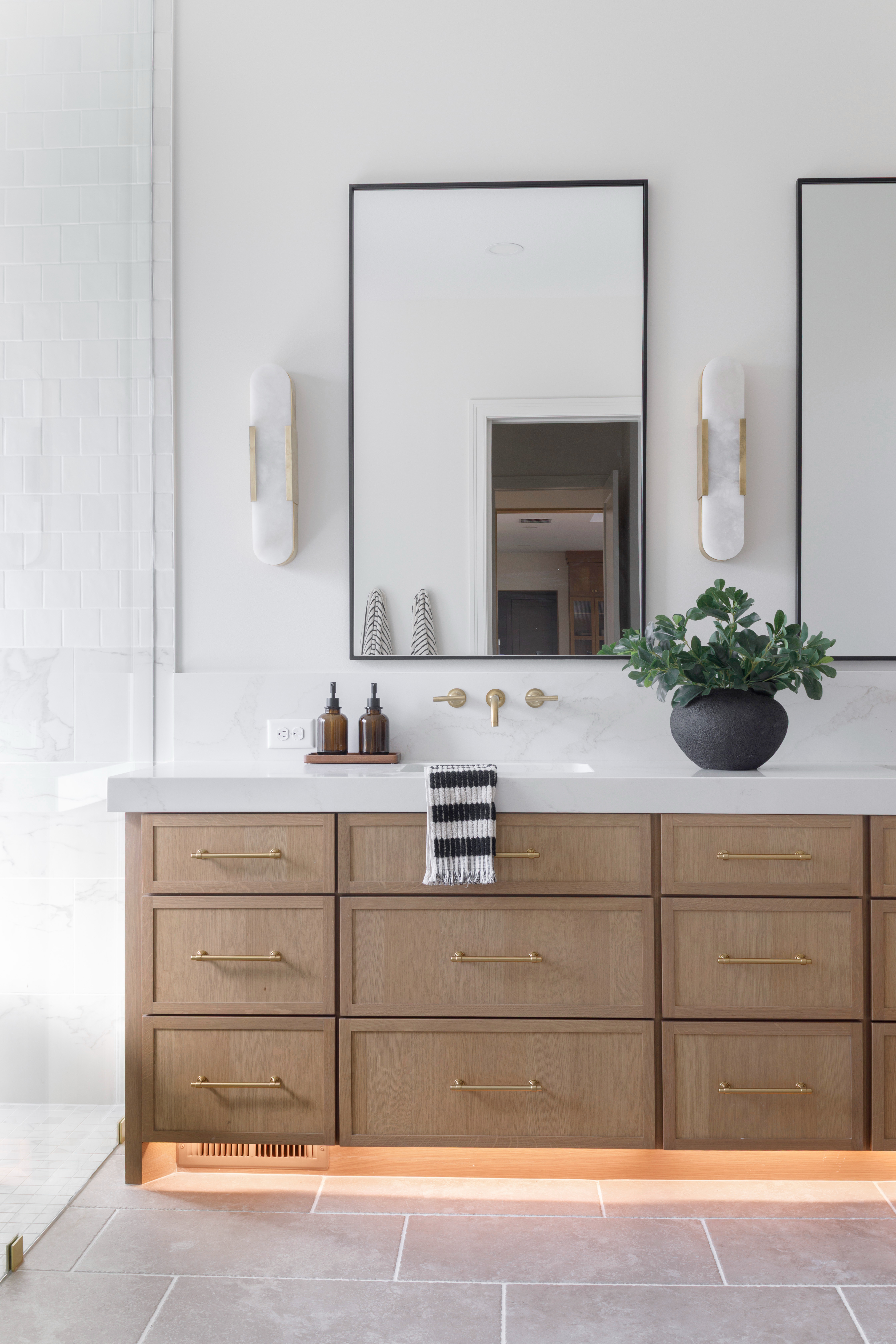 This vanity setup combines timeless design and functionality — featuring brass cabinet hardware, framed wall mirrors, and white alabaster wall sconces that give off a soft, elevated glow. Styled with amber soap dispensers, a textured black vase, and realistic faux greenery, this space brings effortless sophistication to your daily routine.

Everything here is shoppable — from the lighting to the accessories — perfect for anyone looking to refresh their bathroom with pieces that blend organic luxury and modern simplicity.

Shop the exact items below 👇

#LTKhome #LTKbathroom #bathroomdesign #bathroomlighting #bathroomvanity #modernbathroom #bathroomdecor #LTKfinds #LTKstyle #bathroommakeover #bathroomhardware #bathroommirror #brasshardware #organicluxuryliving #neutraldecor #interiorstyling #modernhome #LTKhomedetails #LTKshop #bathroominspo 

 #LTKHome #LTKStyleTip #LTKFamily