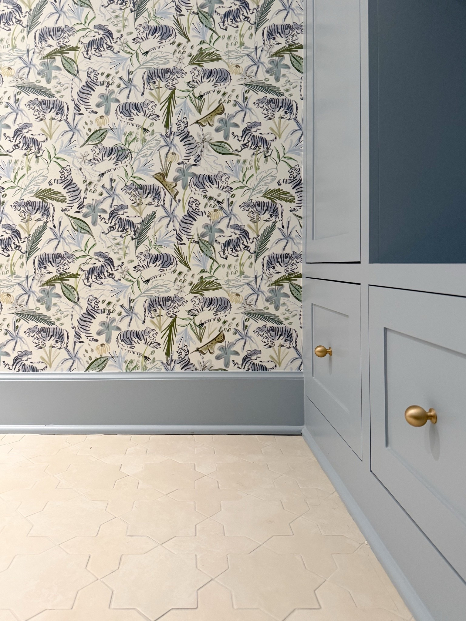 We pulled Manor Blue straight from the wallpaper and used it on the built ins, trim and door to tie the whole room together. I love how the soft blue grounds the bold tiger print and works with the tonal tile floor.

powder room design, blue cabinetry, Manor Blue, tiger wallpaper, patterned tile, built in storage, bathroom paint color, small bathroom ideas, interior design, Girl on the Hudson

#LTKSeasonal #LTKHome