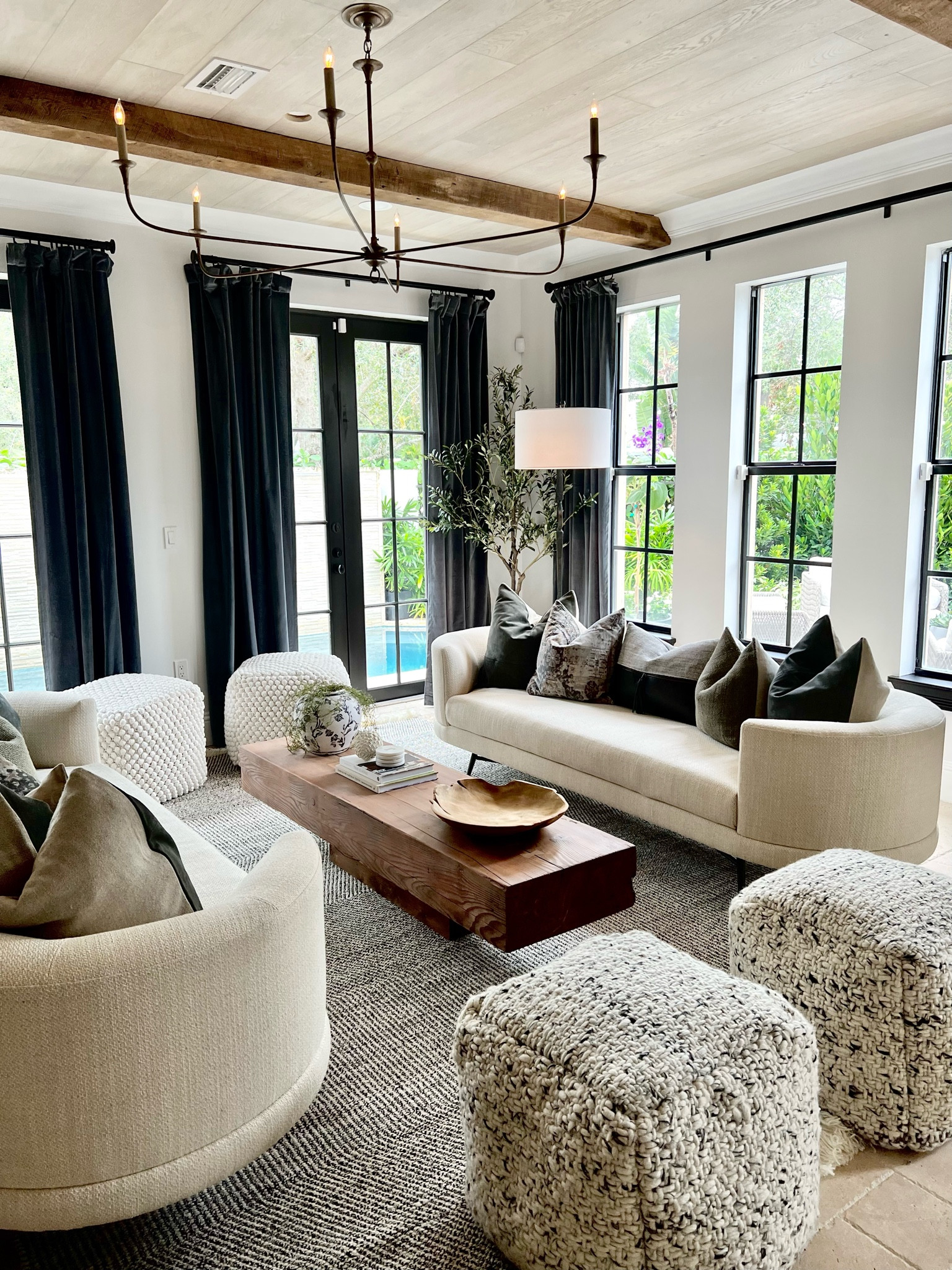 Living room from episode 3 of ‘Home in a Heartbeat with Galey Alix’ on HBO MAX! I created this sophisticated yet cozy space for my bachelor friend Dan so that he has a place to entertain friends & family now that he’s becoming an empty nester. The key was adding extra seating, mixing the poufs and throw pillows, and making sure the ceiling had wood paneling AND beams. Lots of activity up there! 💗

#LTKmens #LTKhome #LTKstyletip